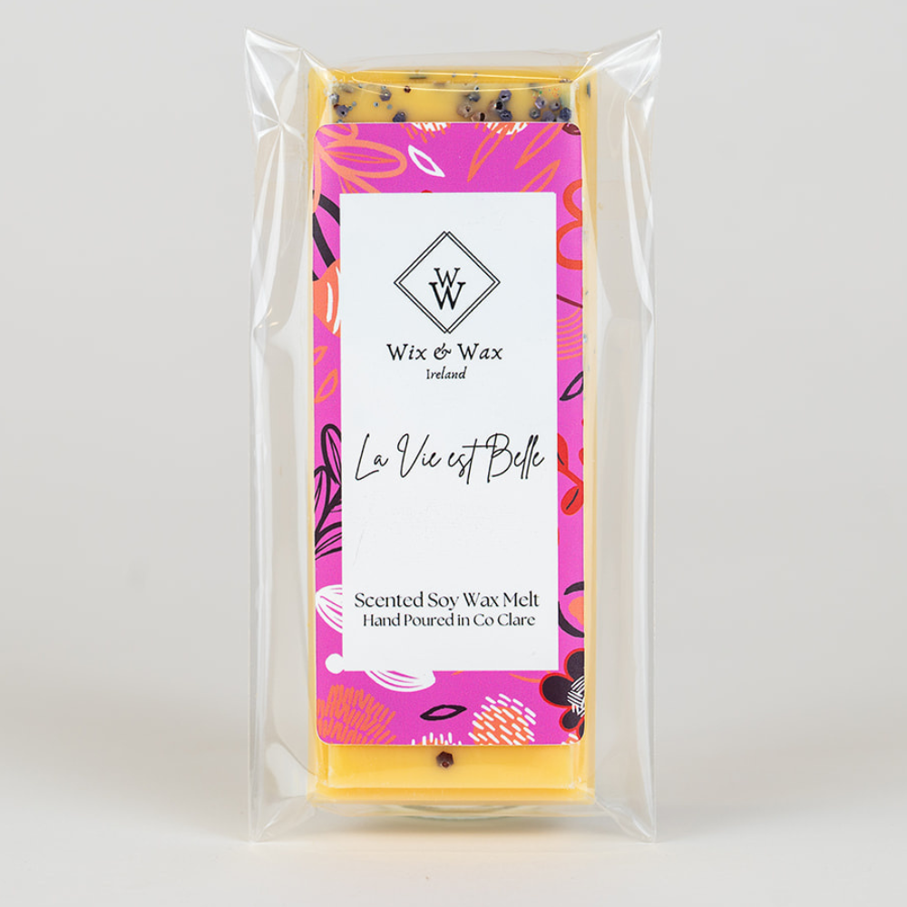 Wax melt package with colorful label and clear plastic wrapping on a white background