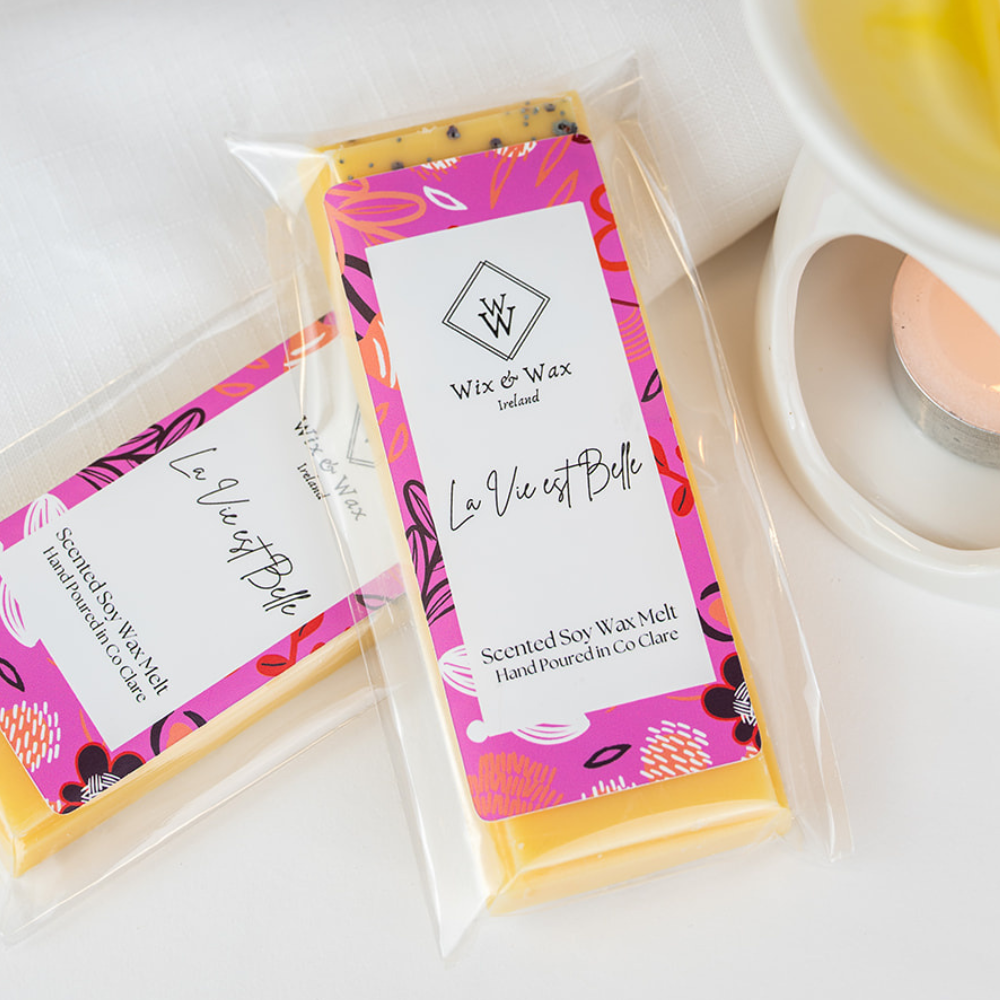 Wax melt packaging with 'La Vie est Belle' branding on a white surface.
